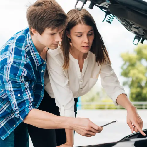 Buying a used car checklist step with buyers checking engine condition under car hood